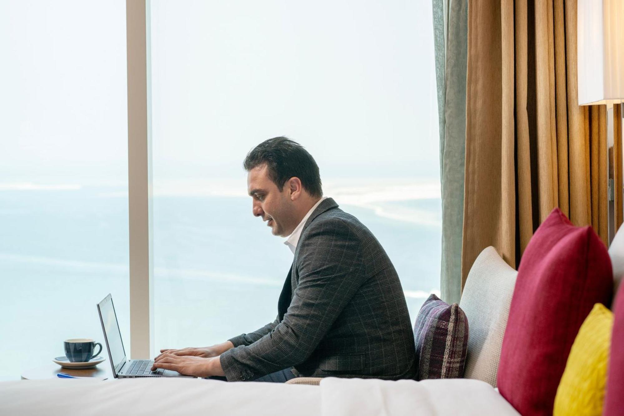 Delta Hotels By Marriott City Center Doha Ngoại thất bức ảnh A businessman working on a laptop